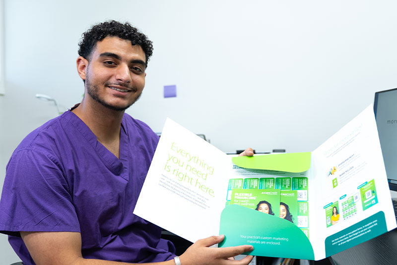 team member going over insurance forms with Patient