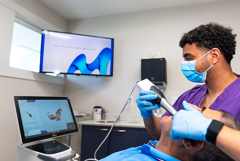 team member taking a 3d scan of Patients teeth