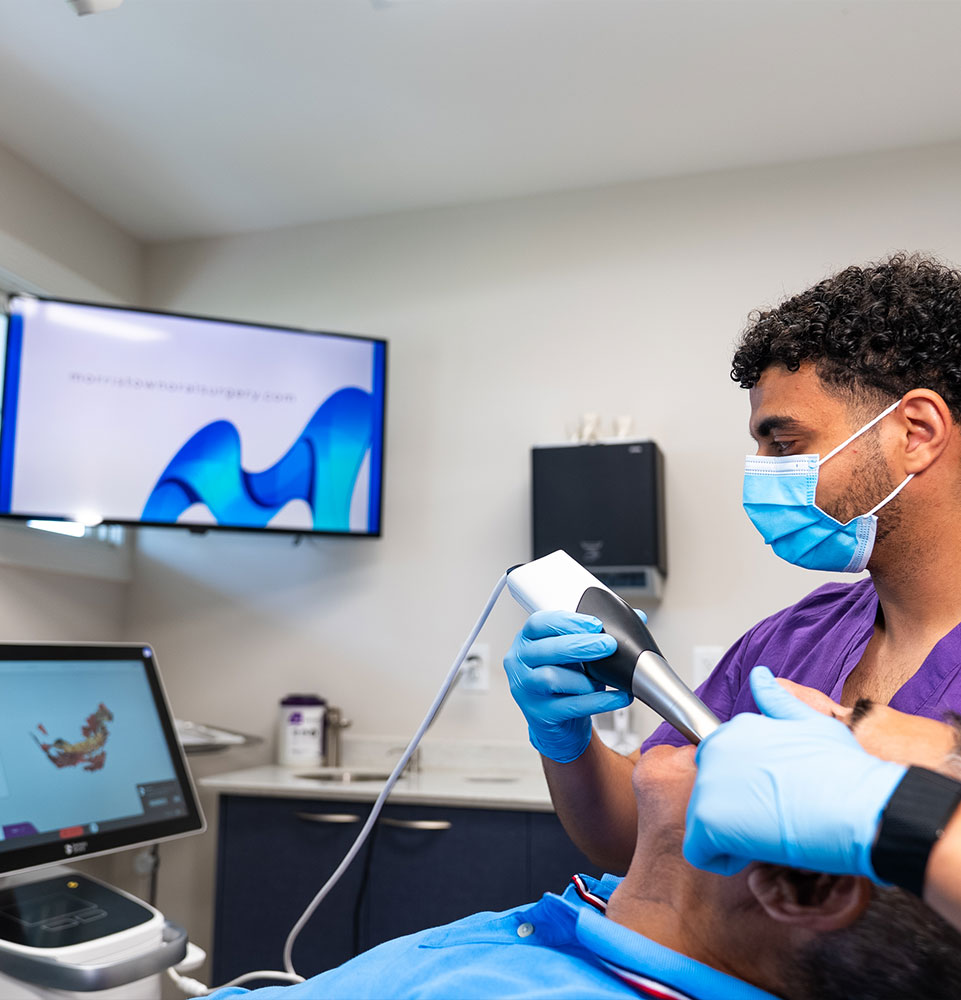 Team member taking a 3d scan of Patients teeth