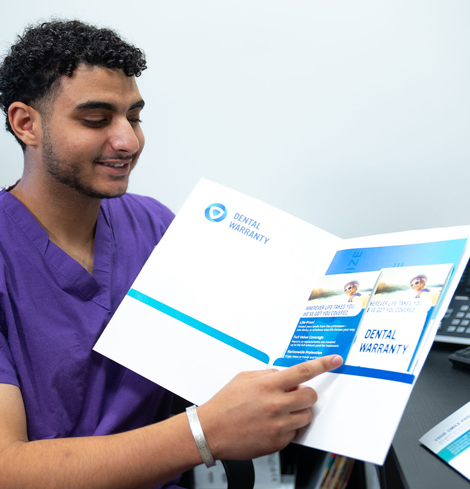 Team member holding up insurance forms