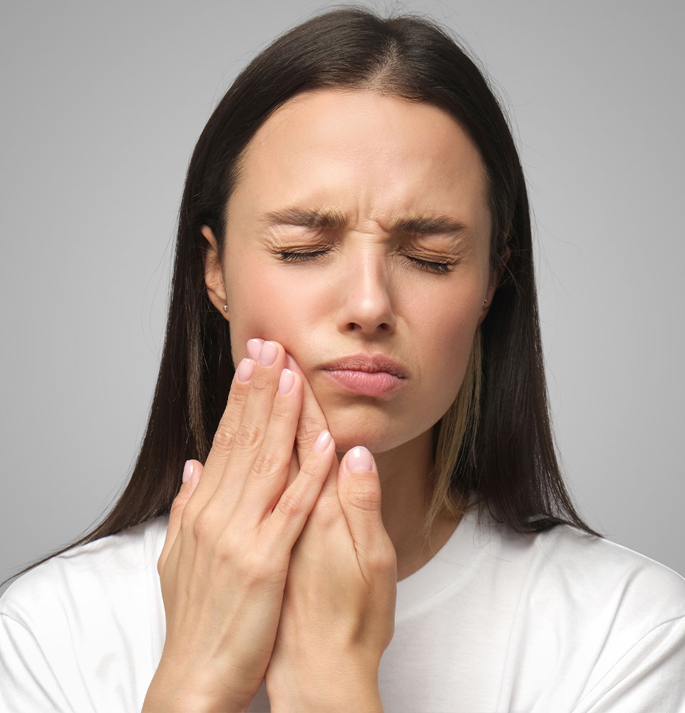 Woman holding mouth in pain
