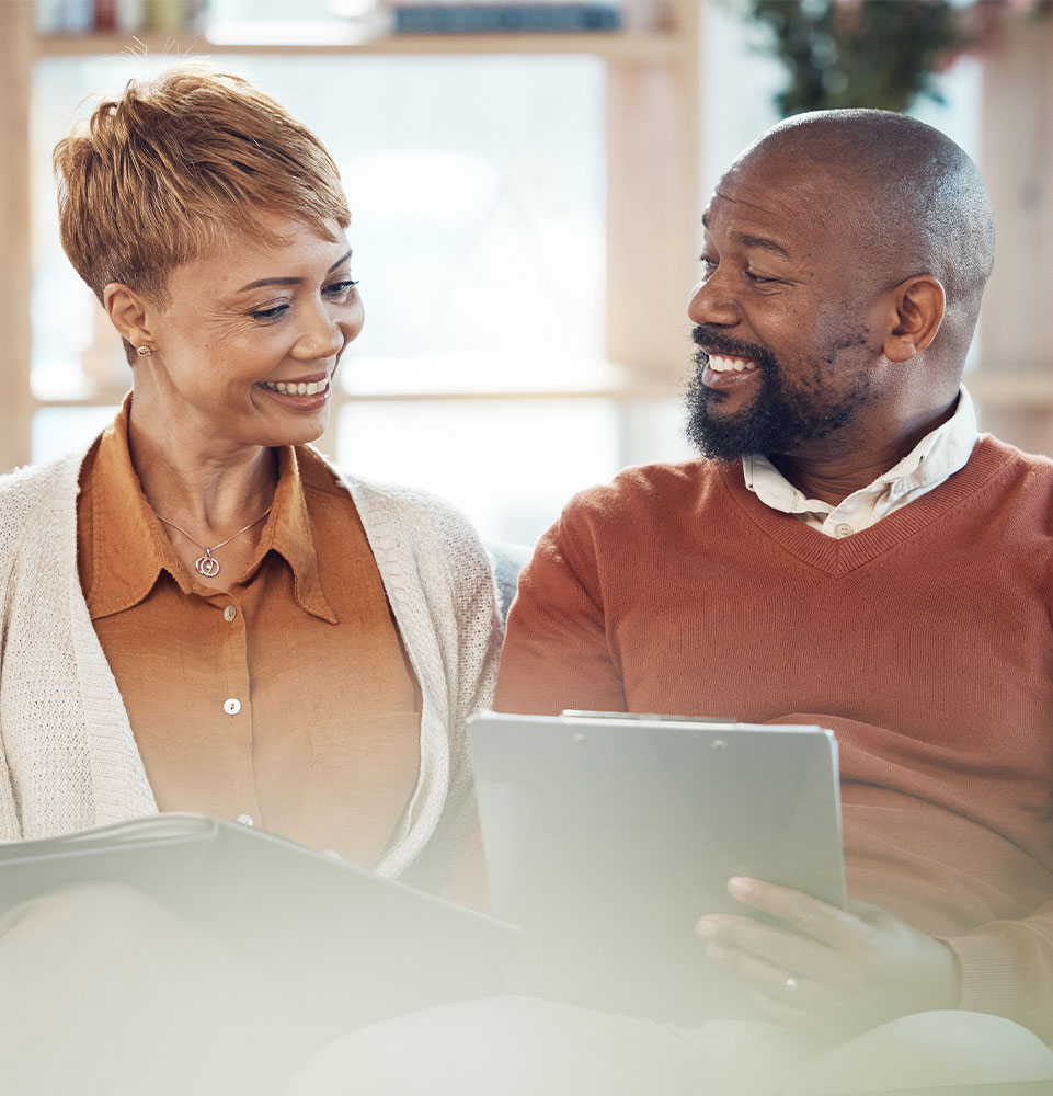 older couple discussing dental implant cost