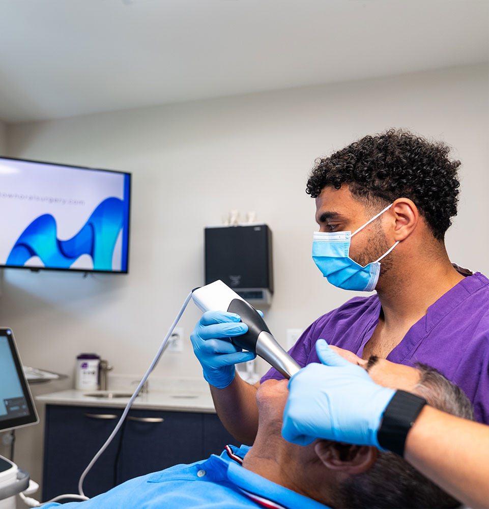 team member taking a 3d scan of Patients teeth